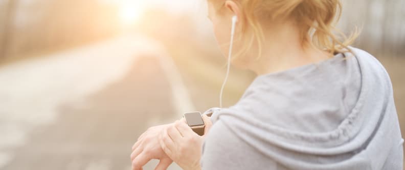 woman looking at fitness tracker