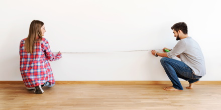 couple measuring a wall