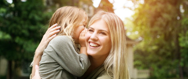 daughter whispering to mother