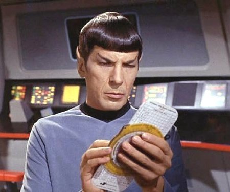 Mr. Spock holding an E6B circular slide rule