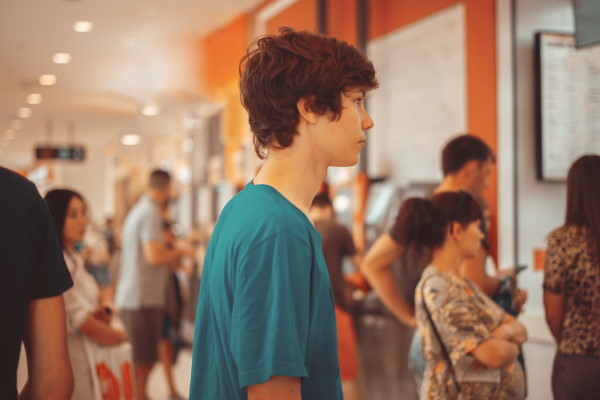 teen standing in a queue