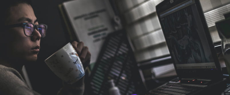 programmer using a laptop in the dark